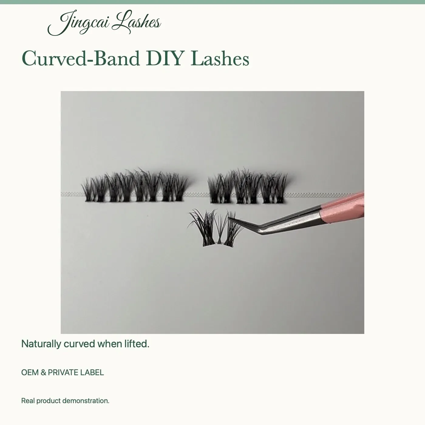 Jingcai DIY lash cluster held at an angle that reveals its curved band, with straight clusters on the tray tape behind it